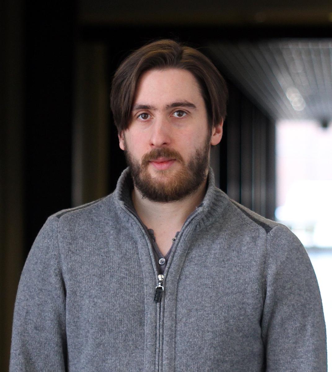 Portrait of male with brown hair wearing a sweater